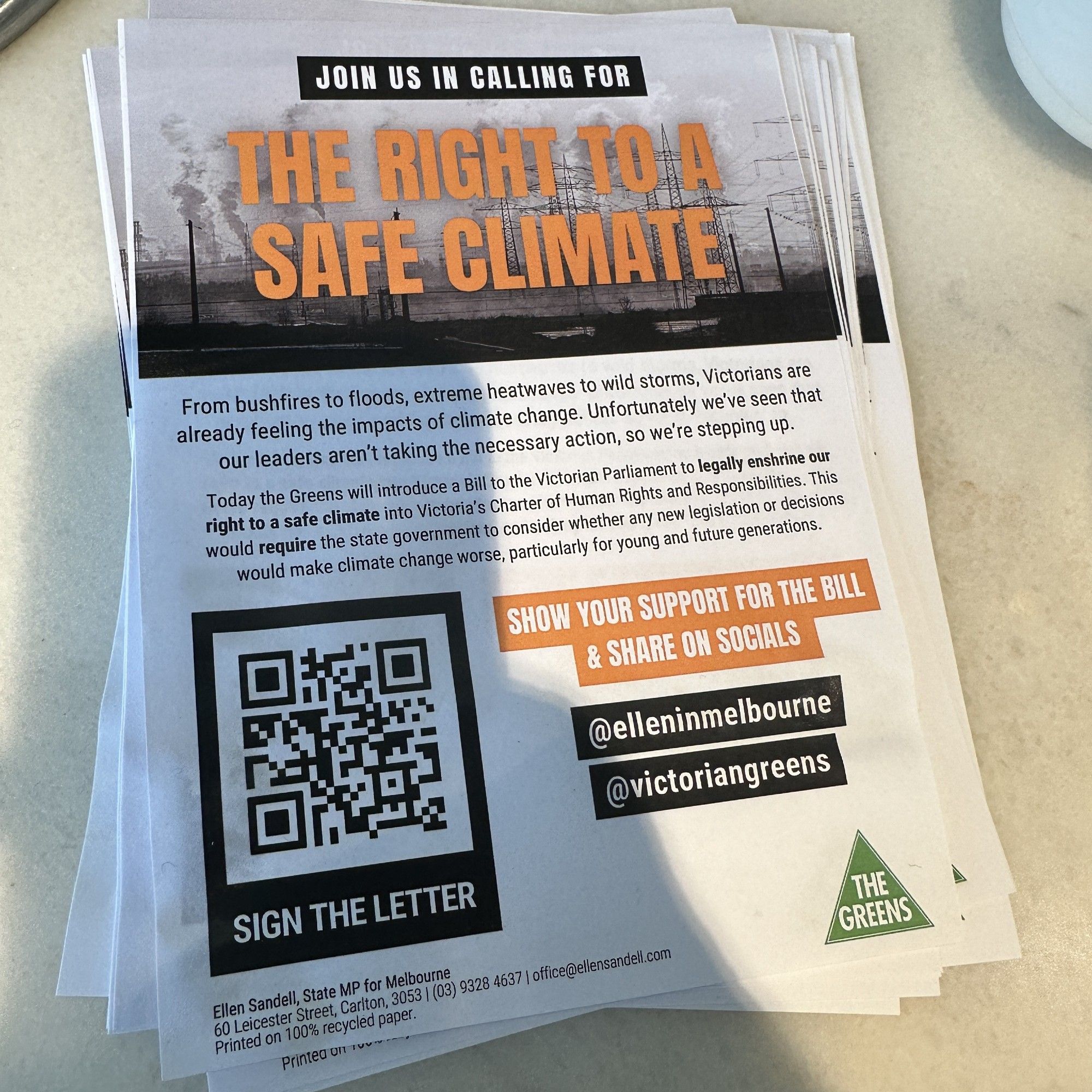 A stack of flyers, calling on people to support the right to a safe climate by signing the open letter to the Premier