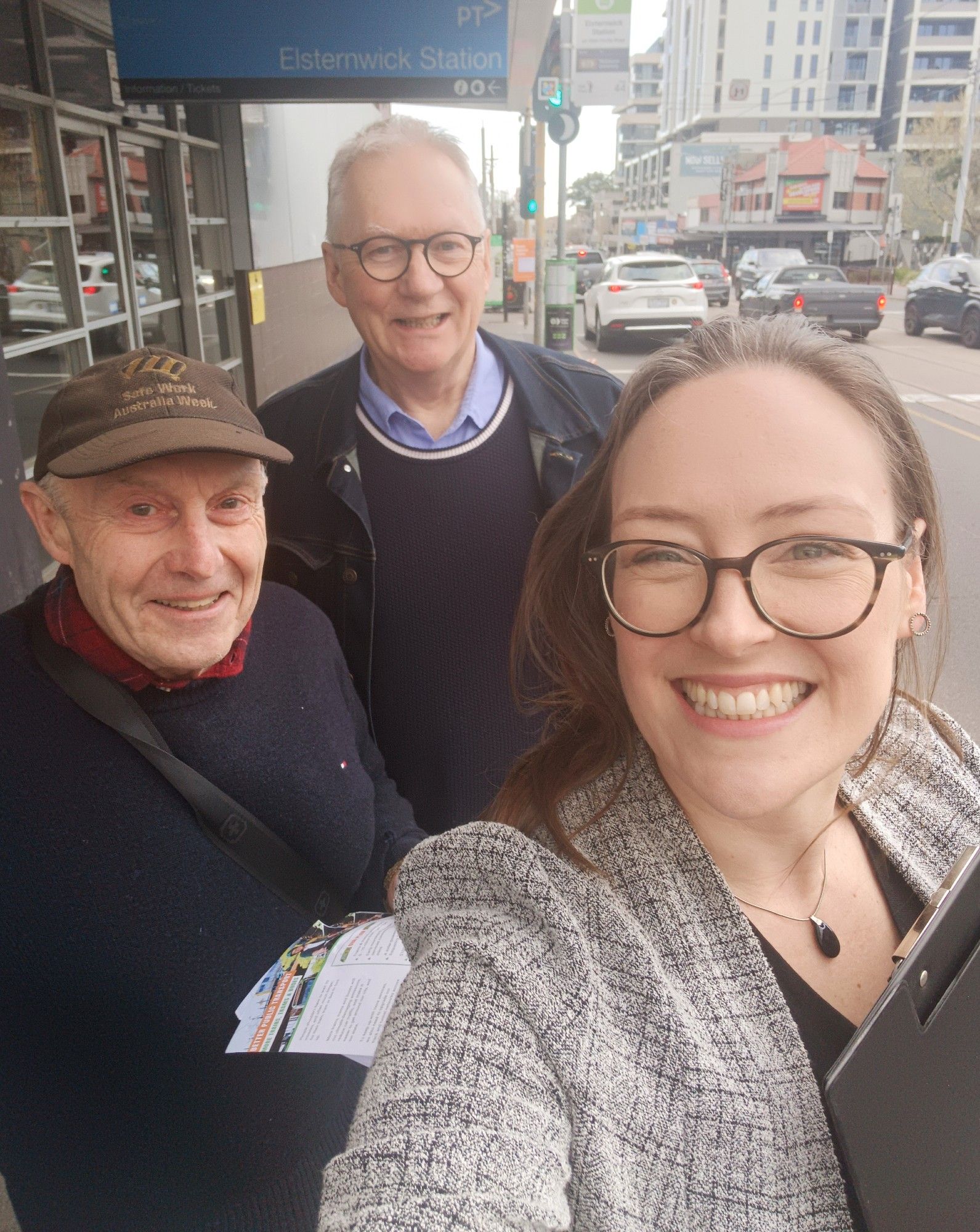 Katherine Copsey MP taking a selfie with two volunteers, on the street in front of Elsternwick Station