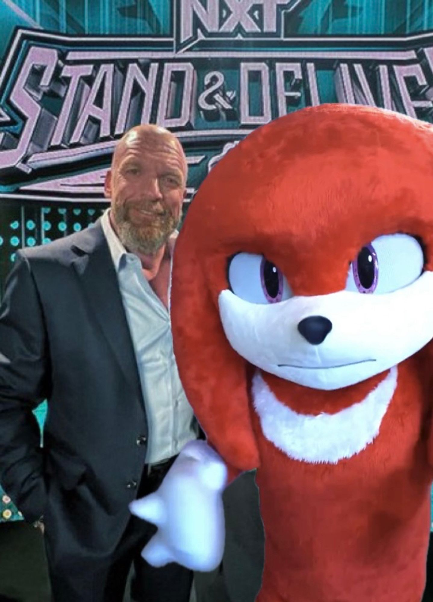 Triple H standing with his newest WWE signing, Knuckles the Enchilada.