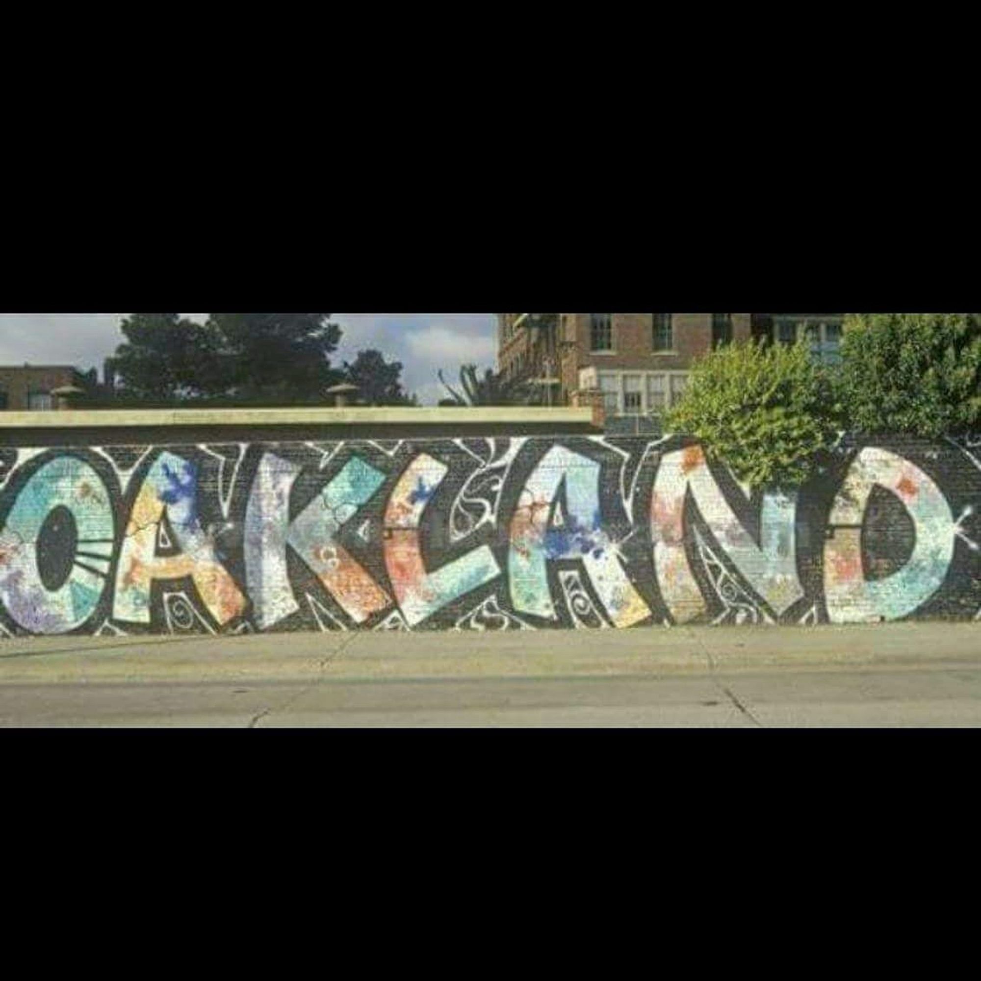 A famous mural that was formerly located in East Oakland on E 12 St. on a wall behind the former Catholic hospital. It was painted over and after an outcry was redone. It says “Oakland”