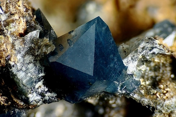 This is my current favorite quartz, blue quartz. These crystals are rare, but tumbles or blue quartz are readily available. It's got an irregular hexagonal shape in the photo and is growing in the center of what looks like chalcopyrite or pyrite.
(But knowing quartz, that could also be gold)