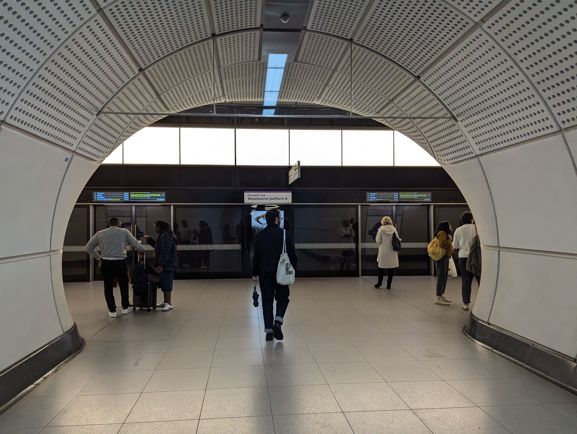 Tunnel opening onto the Crossrail platforms, with platform doors for trains visible, closed.