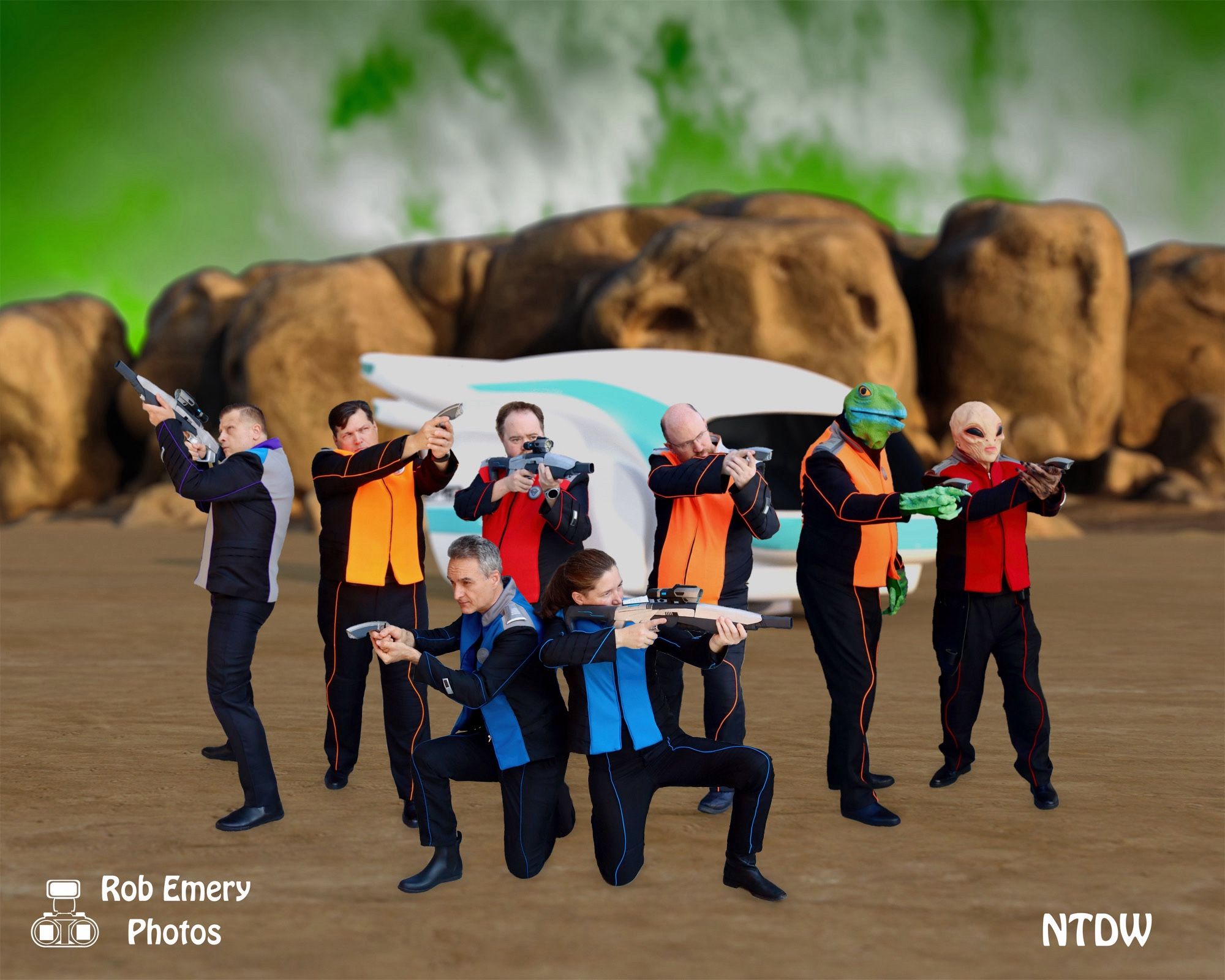 A group of Orville cosplayers with weapons defending a shuttle craft from unseen foes.