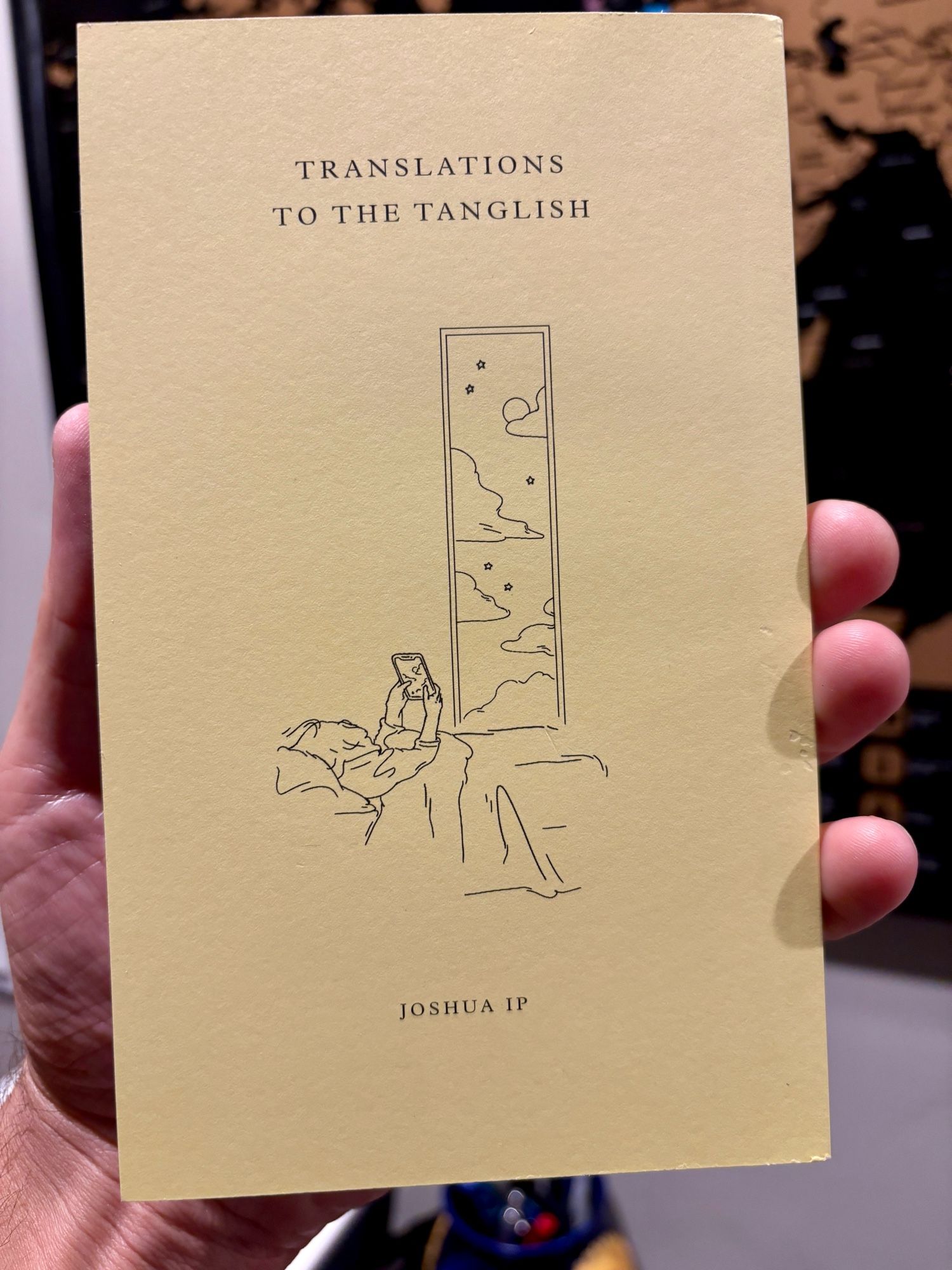 Cover: Translations to the Tanglish by Joshua Ip. Yellow background, line drawing of a person in bed looking at a screen.