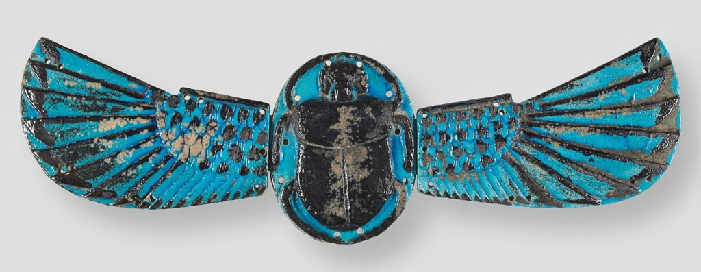 This Romano-Egyptian mummy amulet or ornament consists of three pieces: the scarab in the center and each wing. The piece is supported on a modern steel mounting plate pierced by threaded screw hole in center. 

The scarab is oval with animal in reli...

Harvard Art Museums/Arthur M. Sackler Museum, Gift of Schimmel Foundation, Inc.