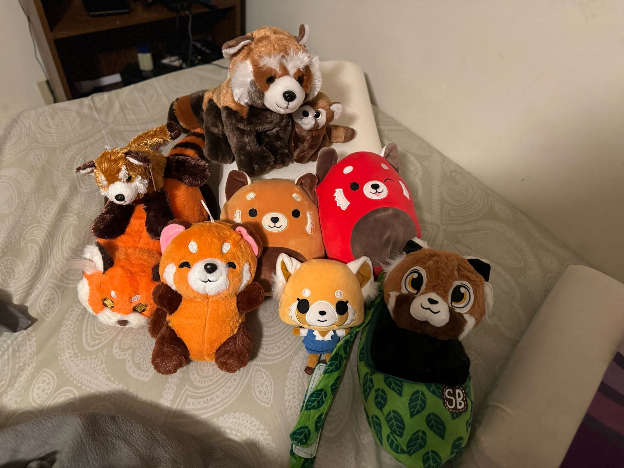 A photo of a large number of Red Panda plushes.