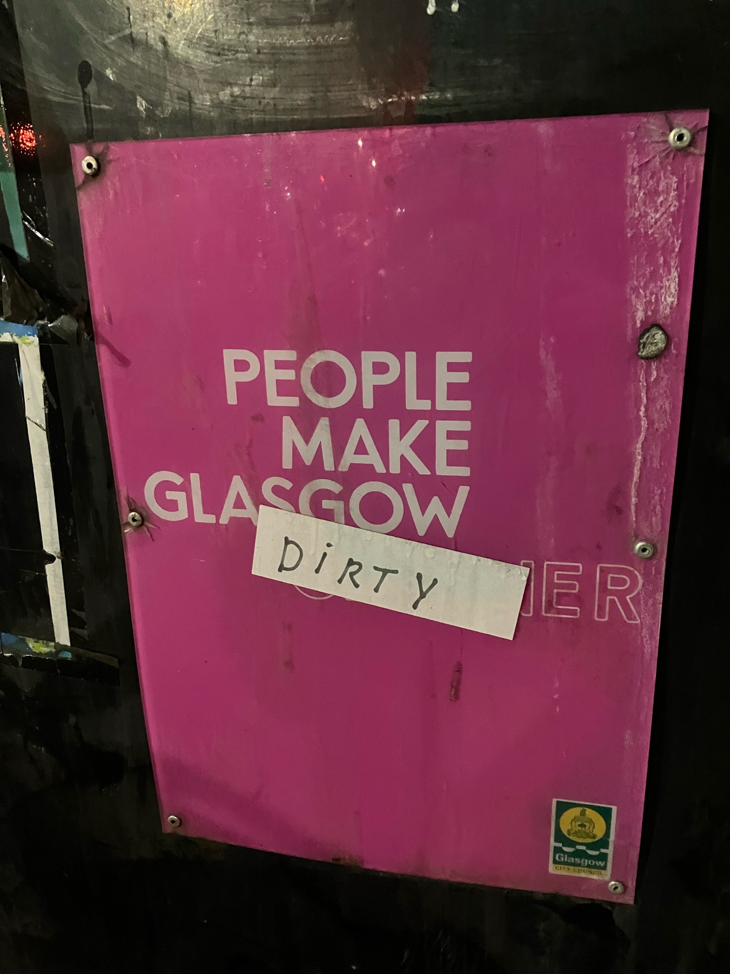 “people make Glasgow” slogan on bin, someone has added sticker with the word “dirty”