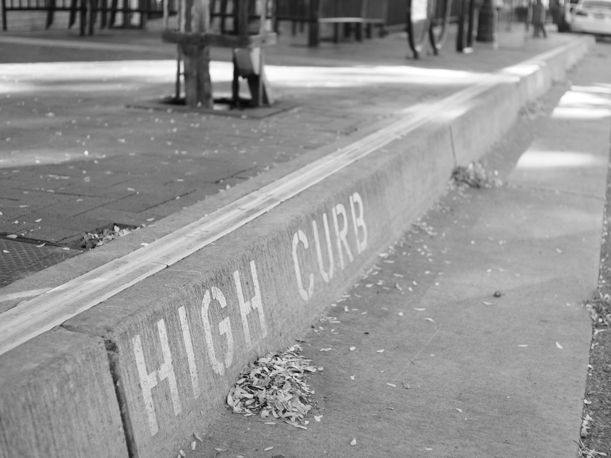 Image of a curb stamped with the words “high curb.” This must be the name of the album.