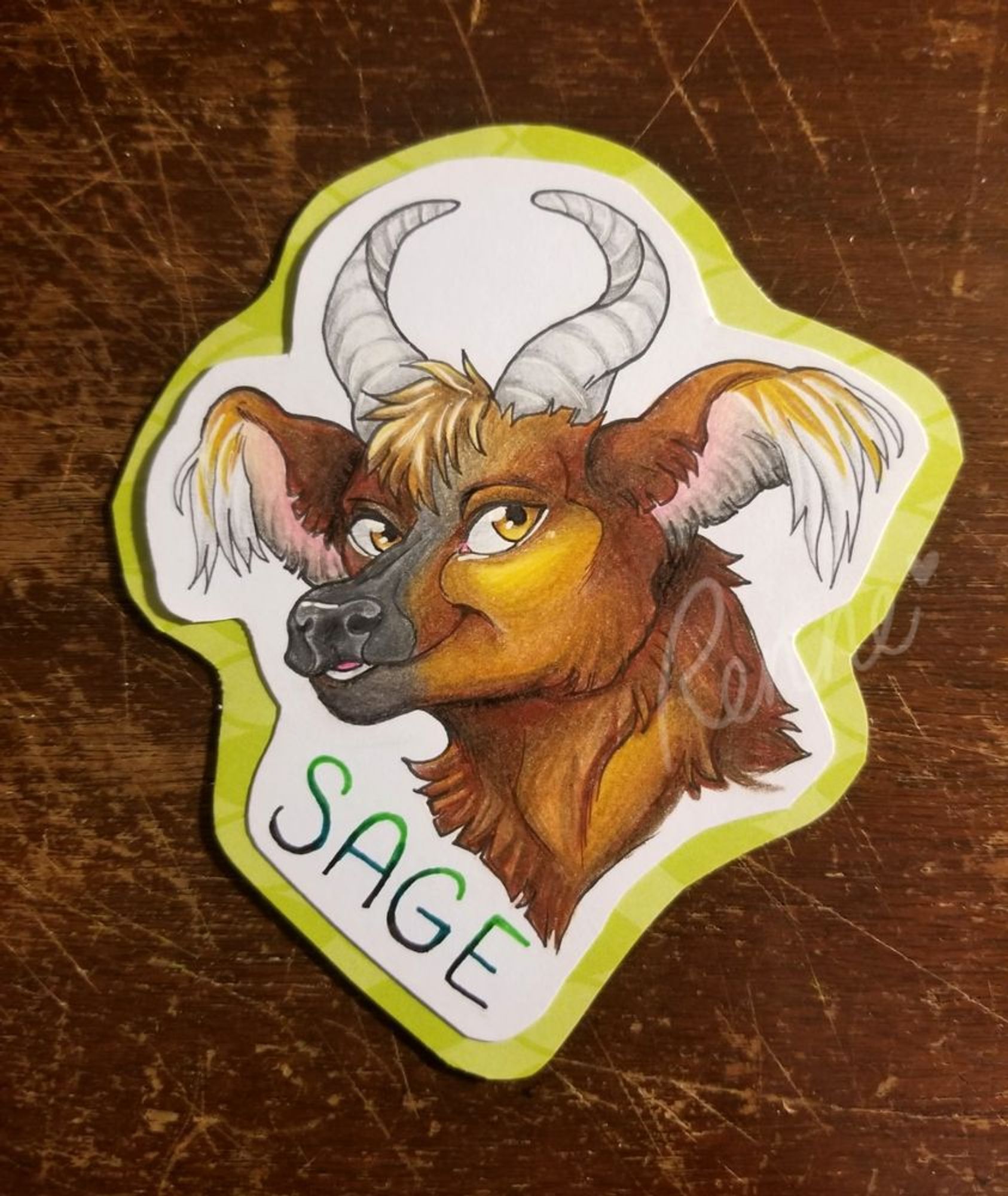 a portrait of an anthropromorphic bull laminated and with a clip to be worn as a badge