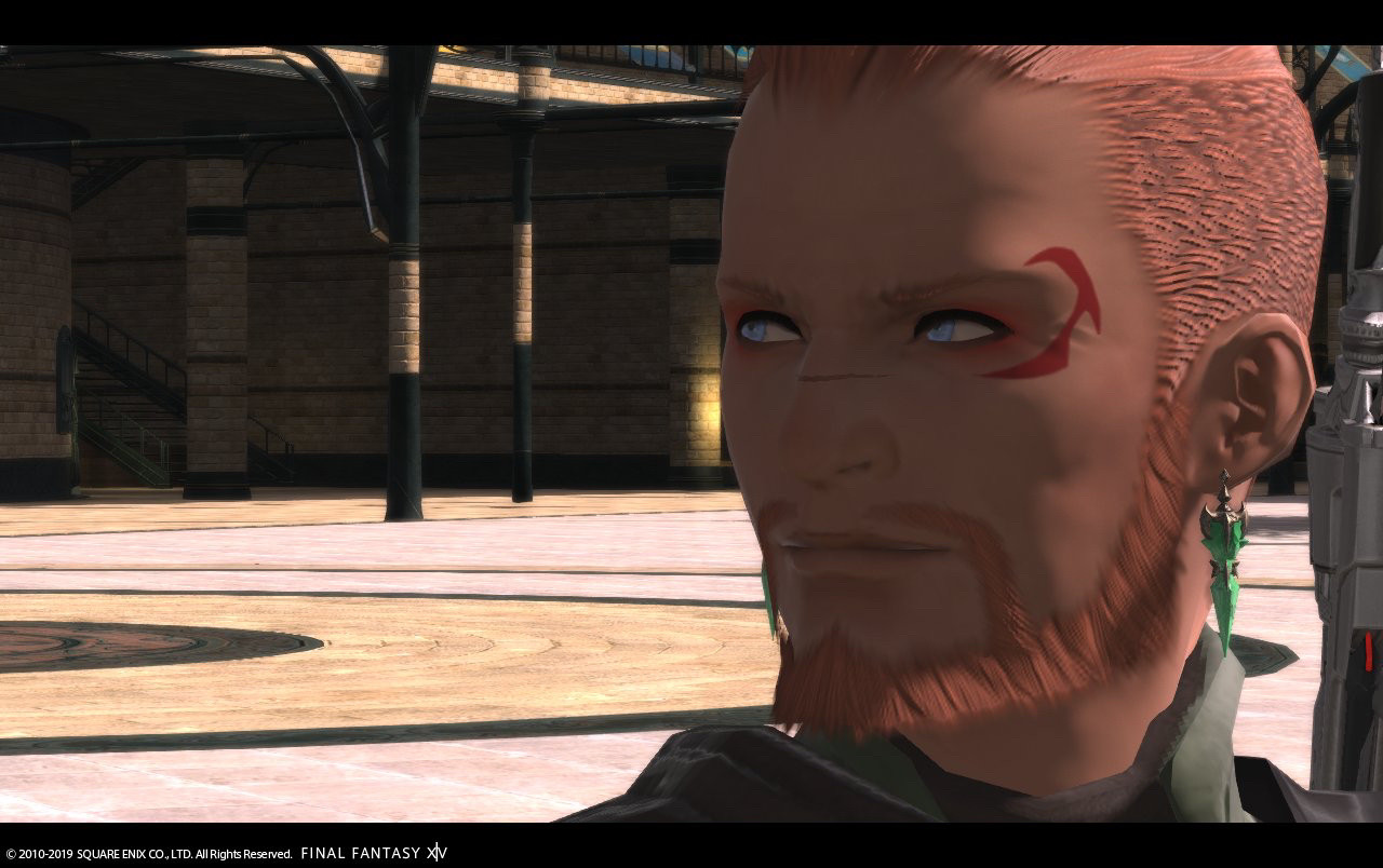 Another ingame screenshot from a cutscene, a closeup of Cyriac Goose’s face + tattoo, wearing a green set