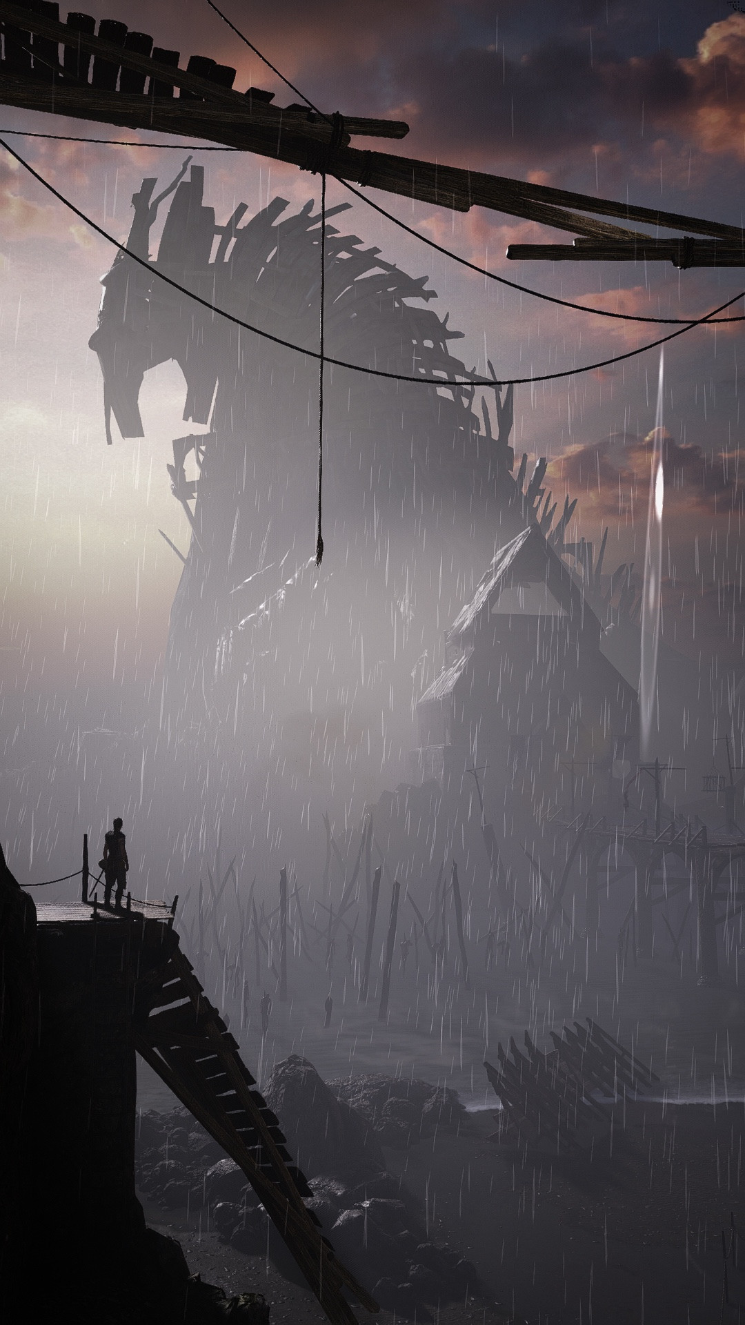 Senua looks off into the distance at the tower of Helheim as rain falls around her. I love the sense of scale in this shot.