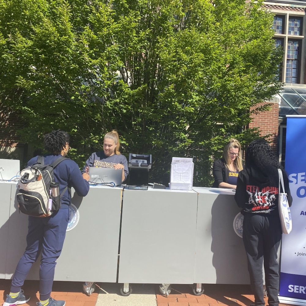 Michigan Department of State staff help students complete their transactions at the mobile office.