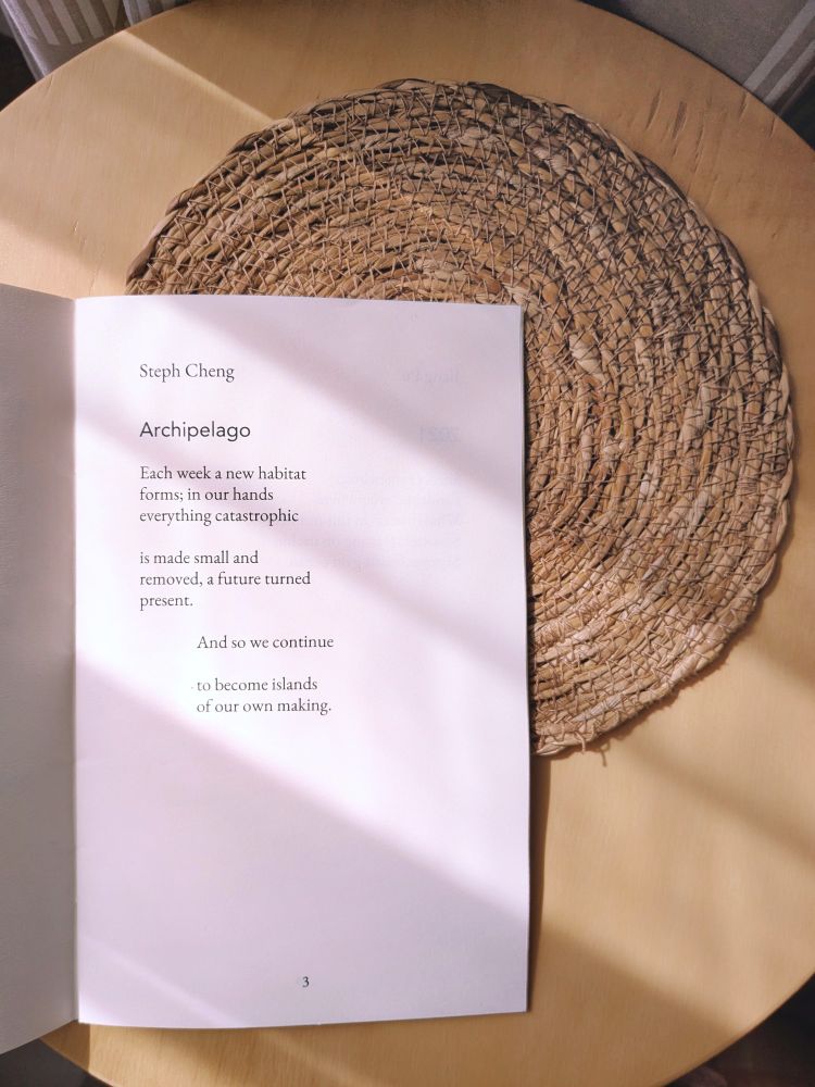 The Earth anthology open to the page with my poem, titled 'Archipelago':

Each week a new habitat
forms; in our hands
everything catastrophic 

is made small and
removed, a future turned 
present.

And so we continue

to become islands 
of our own making.