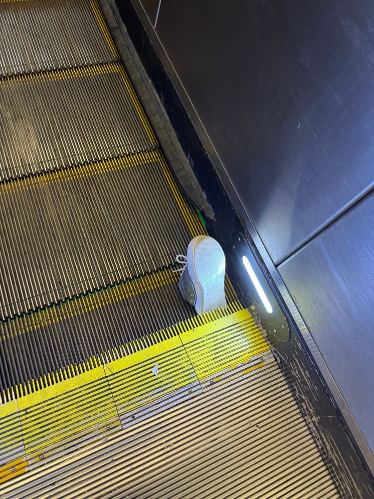 A shoe stuck in an escalator 