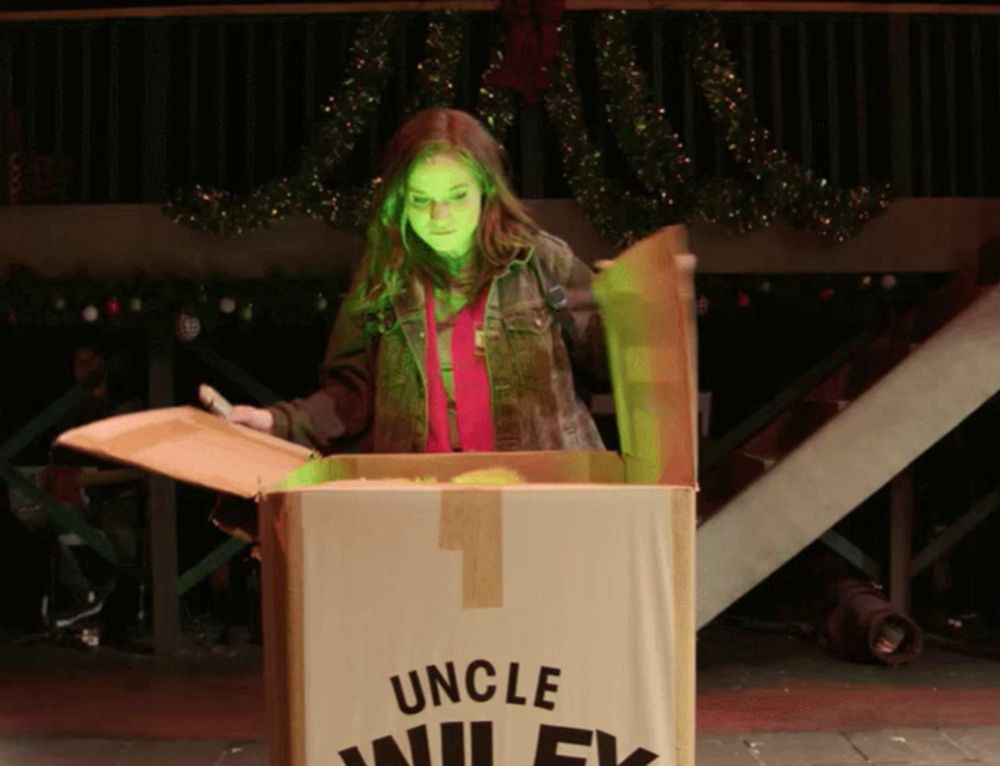 a girl is opening a box that says uncle wiley on it