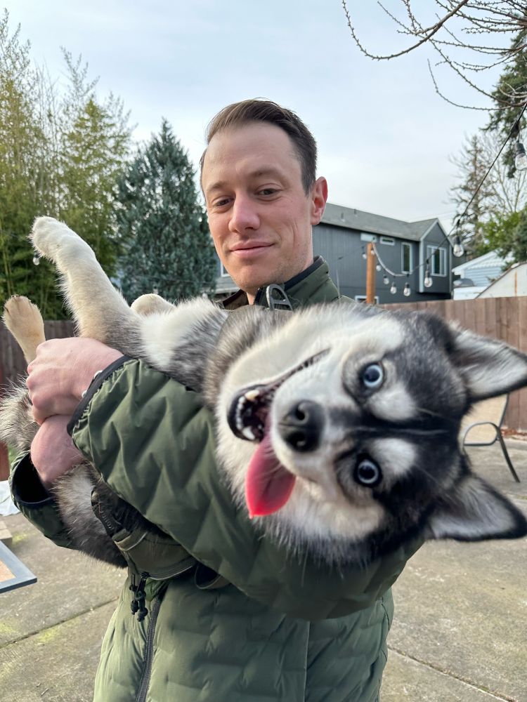 My dog being derpy in my husbands arms