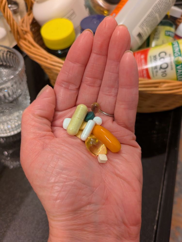 My hand with hopeful but mostly ineffective meds and supplements for long covid 