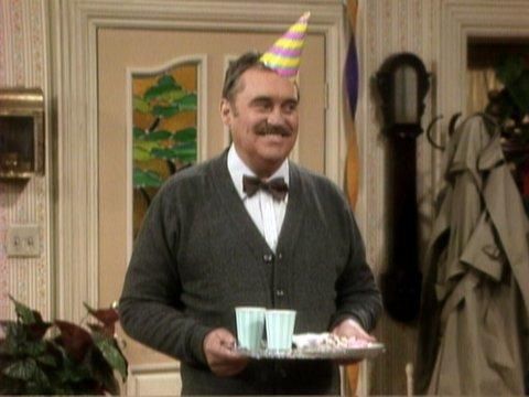 Mr Belvedere with a party hat and drink tray