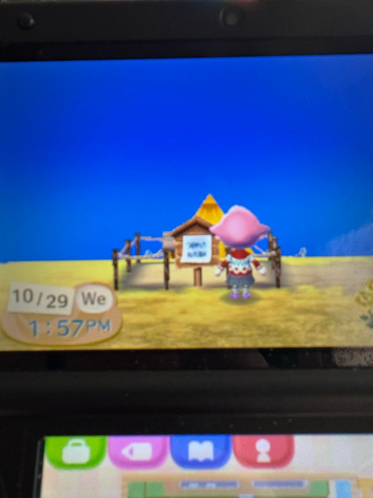 my 3ds showing animal crossing new leaf. my character is standing in front of a housing plot.