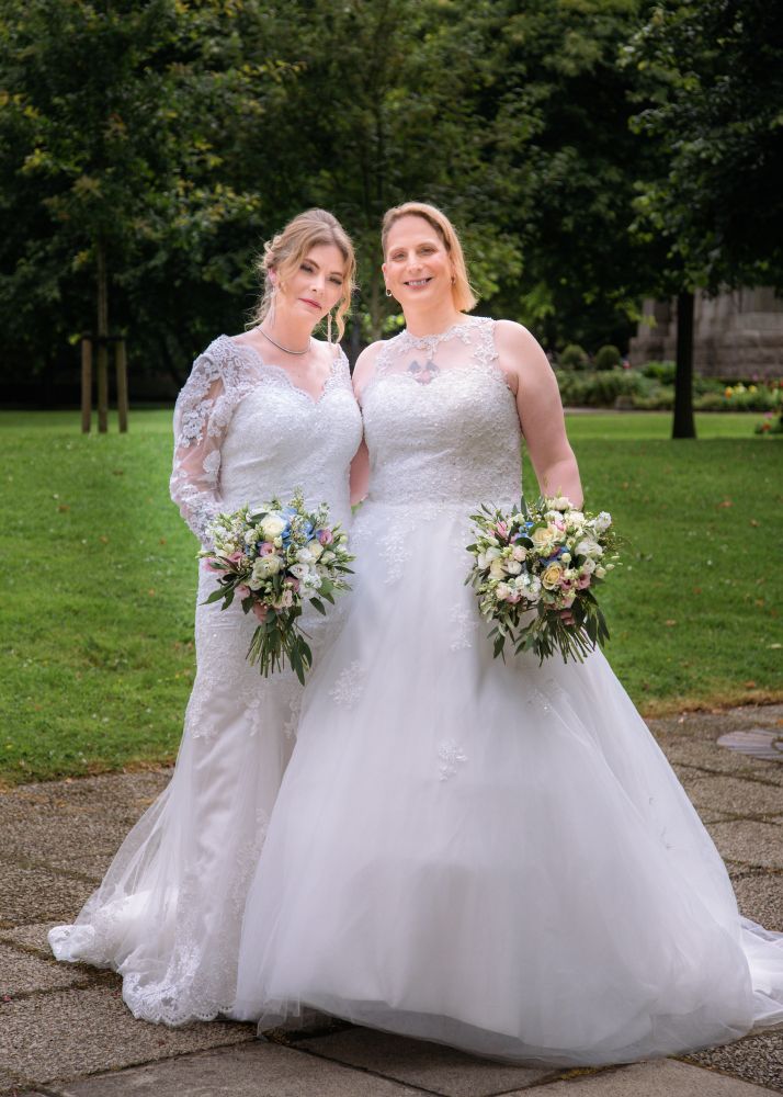 Me and my wife in our wedding dresses 