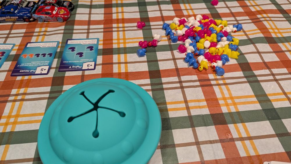 80 multicolored plastic ducks and a rubber UFO. the UFO has an opening like a toddler's snack cup that lets fingers in without spilling the contents.