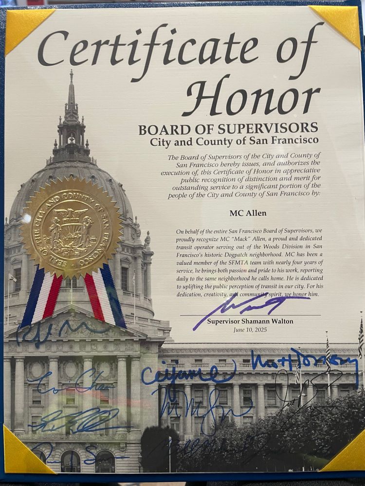 A “certificate of honor” with a picture of city hall signed by the board of Supervisors. It has a gold embossed seal and red white and blue ribbon.