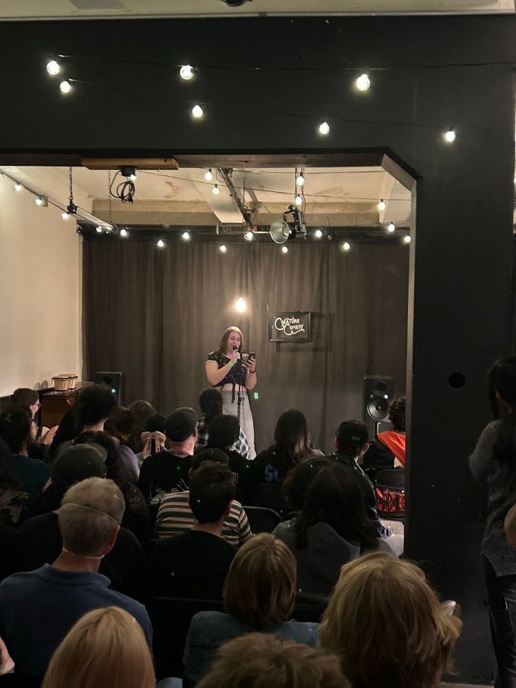 a photo of Nic Anstett reading from a forthcoming book