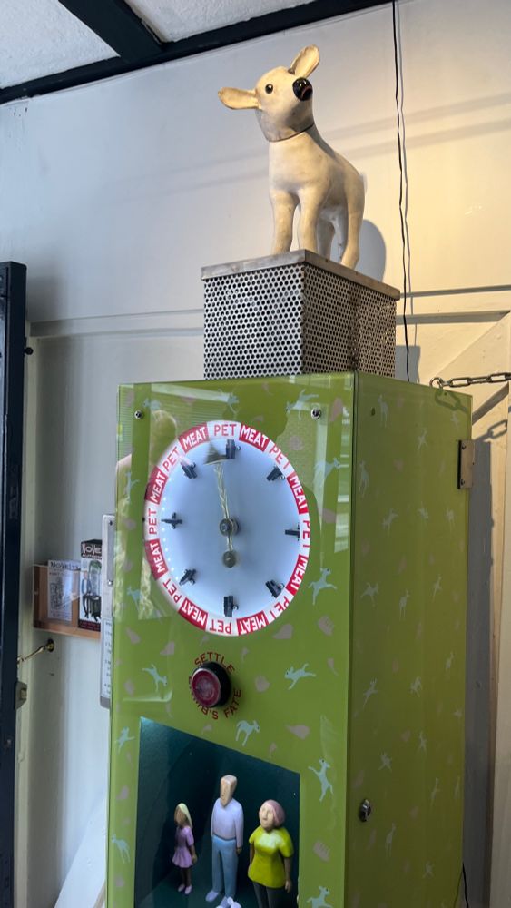 A machine called “Pet or Meat” where a spinning wheel determines whether the adorable lamb is a pet or meat for a family modeled below.