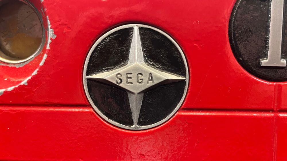 Close up of the Sega emblem on the red slot machine