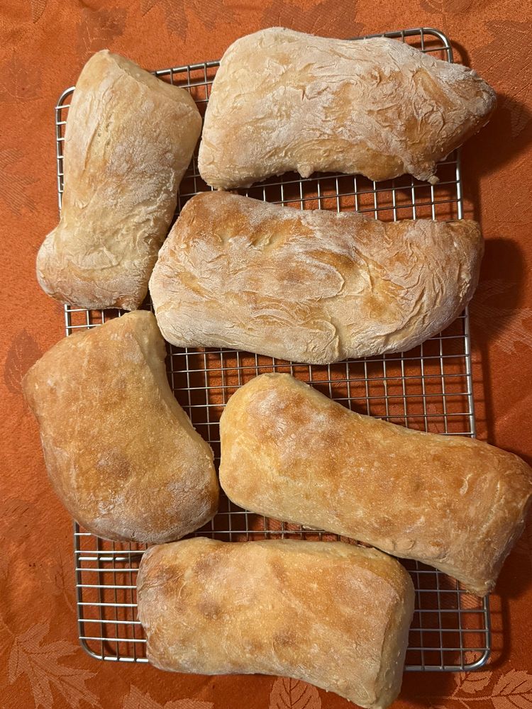Misshapen sandwich rolls on a metal cooling rack 