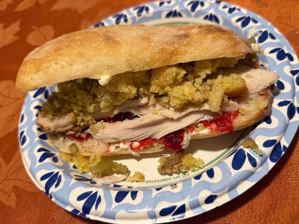 Sandwich made with fresh baked roll, mayo, cranberry orange sauce, smoked turkey, and sausage cornbread stuffing 