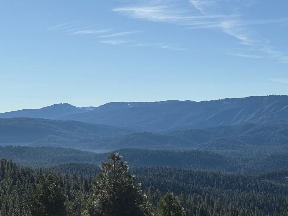 Looking out at mountain ridges and a blue sky 