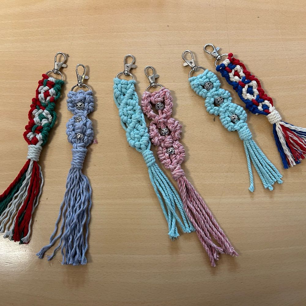 6 macrame key rings in various colours with long fringes. 3 of them incorporate silver beads. 