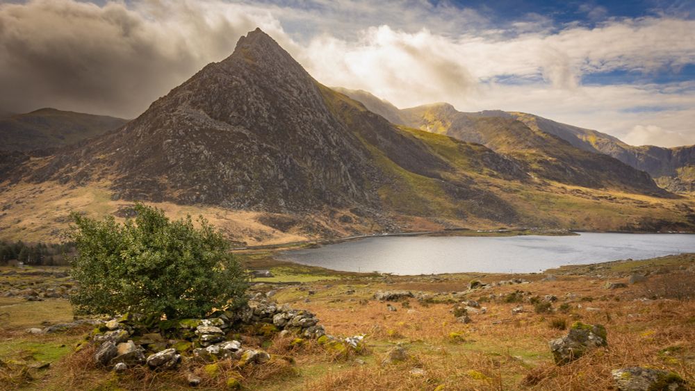 Landscape image of the mountain, Tryfan with the sun rising behind, in North Wales. 