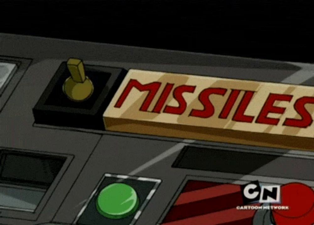 a sign that says missiles on it with a green button below it