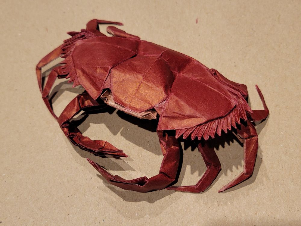 Origami sculpture of a red rock crab