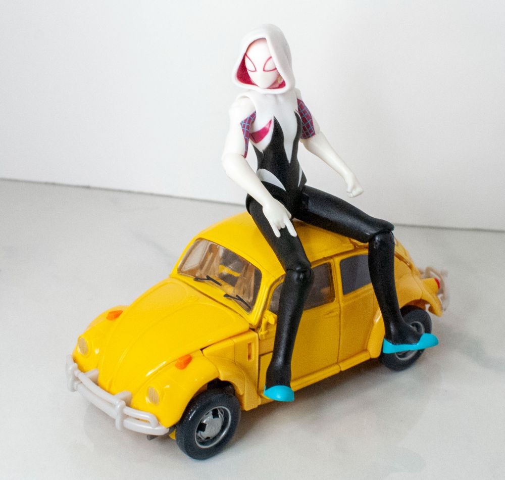 Studio Series VW Bumblebee (Version 2) in vehicle mode, with Epic World of Action Ghost-Spider sitting on his roof. 