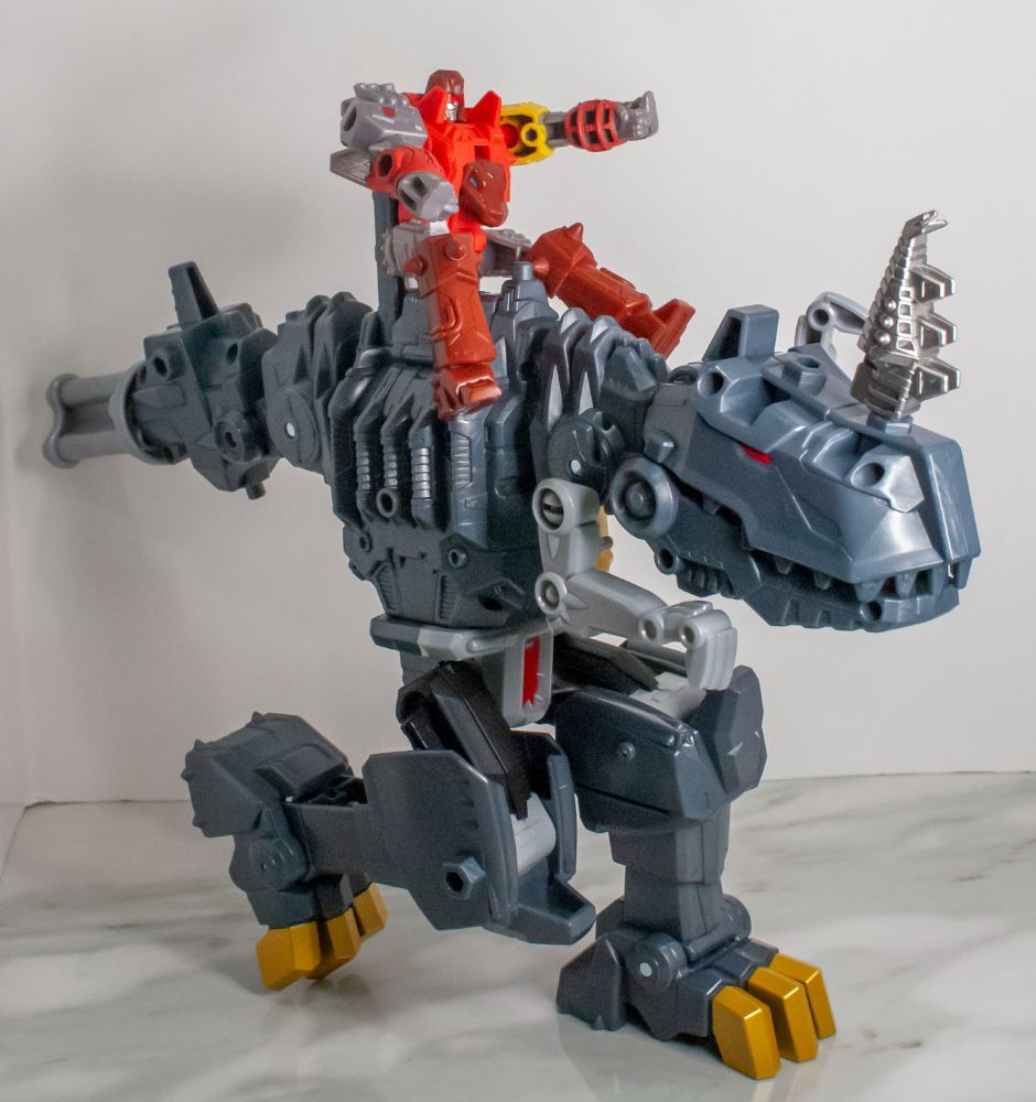 Cyberworld Grimlock being ridden by Snarl. Snarl's sword is being used to give Grimlock a horn. 