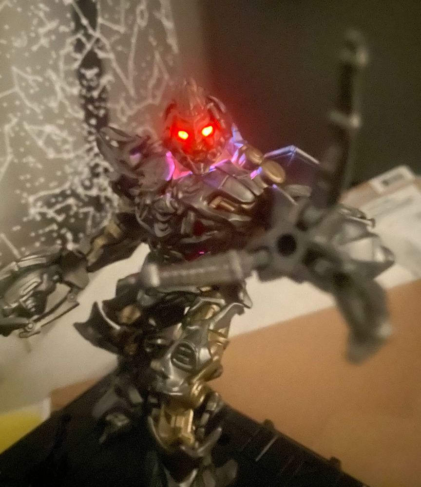 Blokees 2007 Megatron, with his eyes glowing, reaching out menacingly at the viewer.
