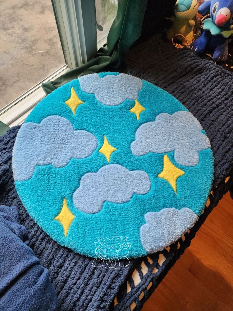 A handmade tufted textile work that depicts light blue clouds and yellow stars on a blue background