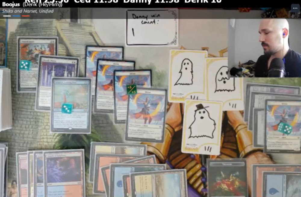 A screenshot of a SpellTable game. There is a playmat with Magic cards on it, and three yellow bordered InfiniTokens dry erase tokens with ghosts drawn on them. One has a top hat, another has a mustache, the third wears nothing.