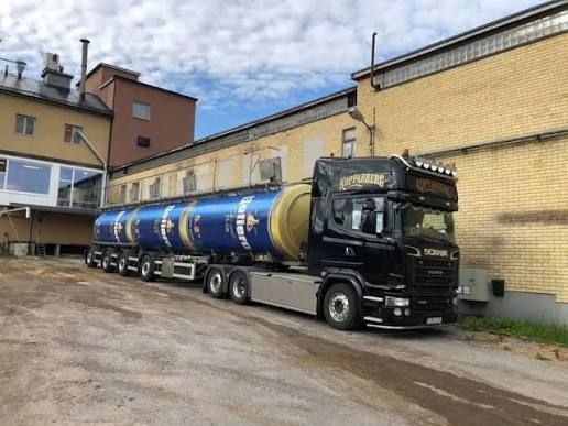 Långtradare med tanksläp. Tanken på släpet är målat så det ser ut som tre liggande ölburkar.