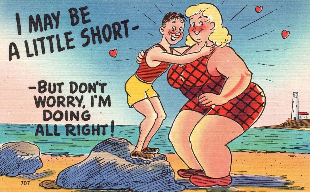 A vintage postcard design of a short, skinny man with brown hair embracing a tall, broad, muscular blonde woman. Both are in swimwear. The two of them are standing on the beach, and the man has to stand on a large rock to reach the woman’s height. Both are blushing, smiling, and looking towards the viewer. The text written on the art reads “I may be a little short— but don’t worry, I’m doing all right!”