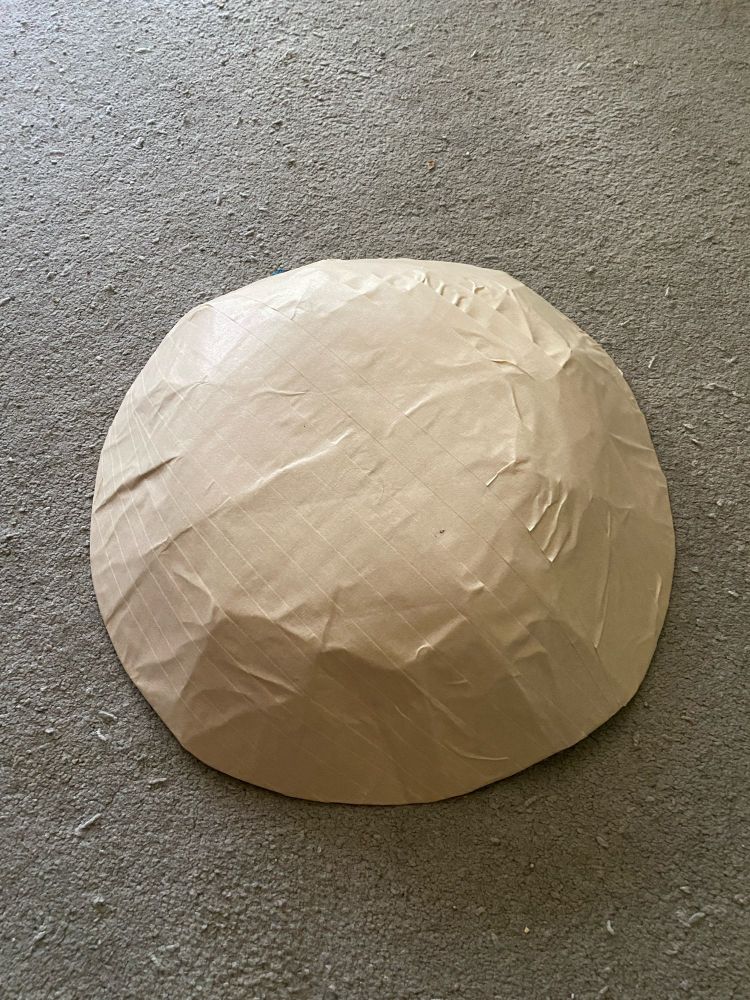 large bowl shaped cut folder covered in masking tape on rug