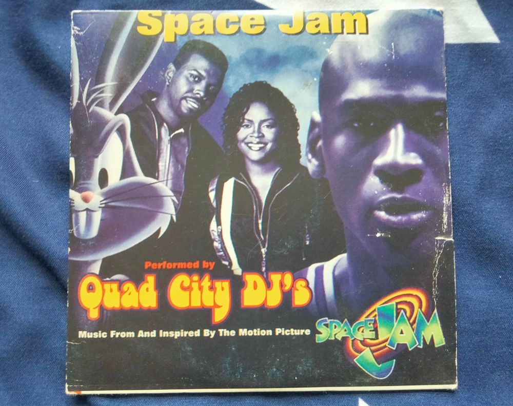 The promo CD for the song Space Jam by the Quad City DJ's, which is the theme song for the 1996 Looney Tunes film Space Jam.

From left to right: Bugs Bunny, Jay Ski, JeLanna LaFleur and Michael Jordan.