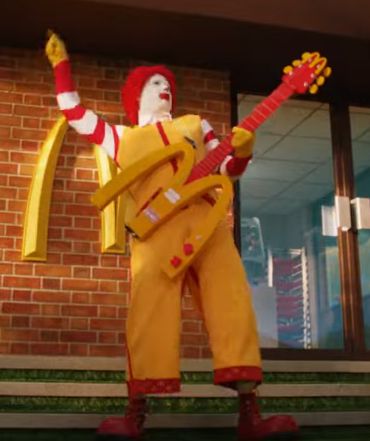 A screenshot from the 2025 McDonald's commercial "McDonaldland Meal".

Ronald McDonald plays the same electric guitar from the "A Day in the Life" commercial.