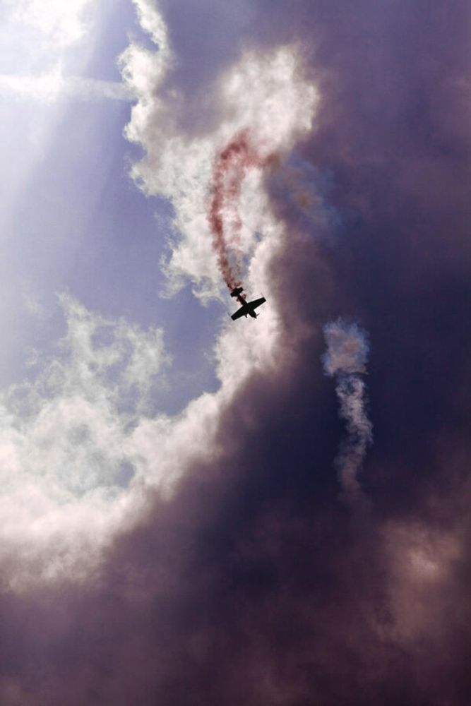 Airplane in an acrobatic flight demonstration by Tatiana Travelways