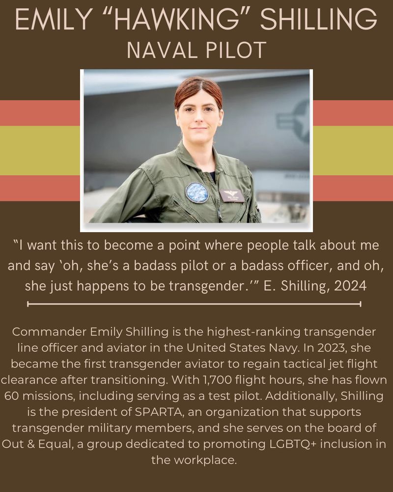 A uniformed female naval aviator with red hair stands in front a jet 