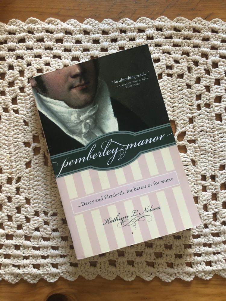 A picture of a book titled Pemberley manor by Kathlyn L. Nelson on a table