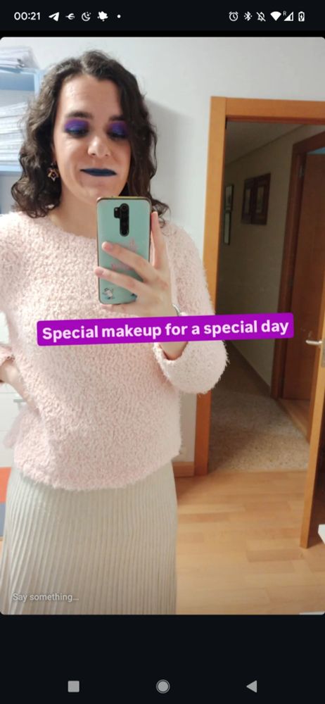 Selfie of me showcasing the makeup, of glittering purple eyeshadow and dark blue lips. There's a text that says "Special makeup for a Special day".